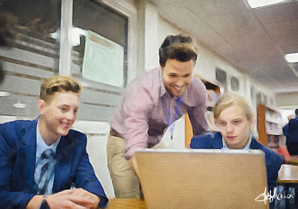 A male teacher helping pupils on a laptop